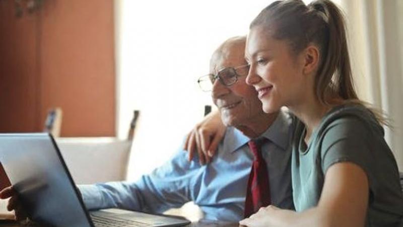 Older man and young woman reading
