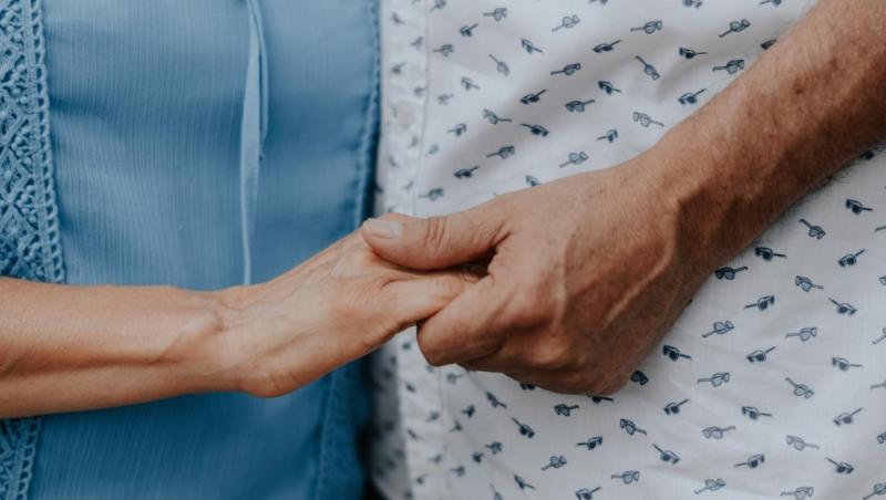 Older couple holding hands