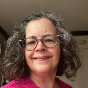 A happy woman in a pink shirt